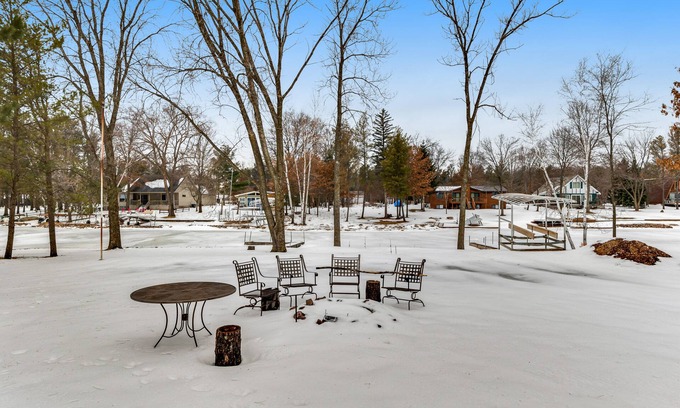 Nekoosa House | Lovely lakefront home with a game room, firepit, dock & W/D - private beach area