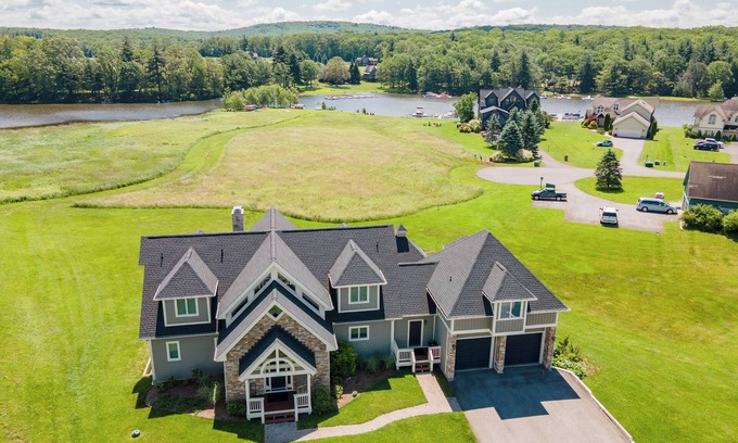 Waterfront Greens House | Luxury Lodge w/Lake Access, Hot Tub & Games