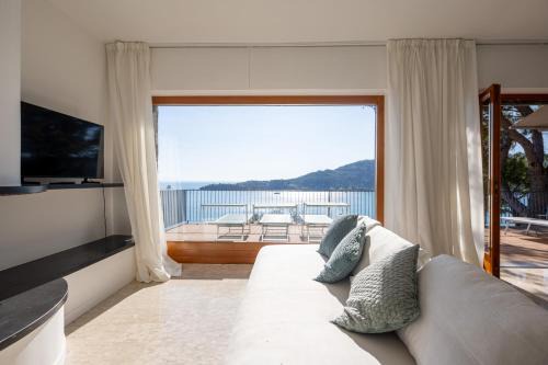 Portovenere Apartment | Modern and Elegant apartment with a spacious sea view terrace overlooking Palmaria Island Bright designer interiors Fully equipped Up to 6 guests Private parking Aircon All the comforts for a perfect stay