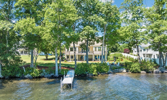 Laconia House | Modern Lake Opechee Home features Sandy Perched Beach and Dock
