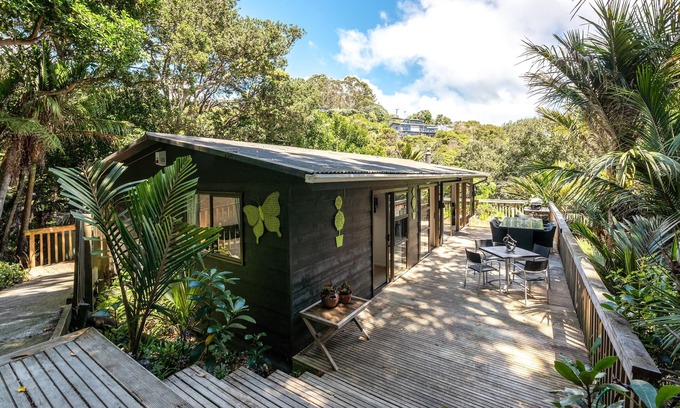 Onetangi Cottage | Near Onetangi beach, Treetops is a family bach on the edge of the forest.