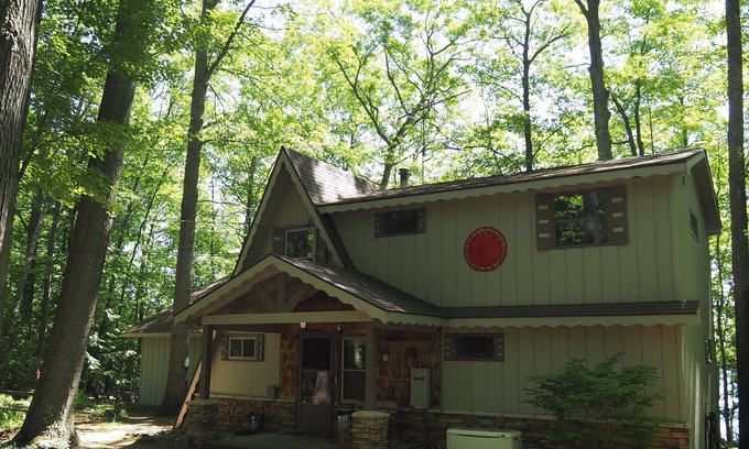 Mancelona Ski Chalet | NEW! Woods and Waters - Large, Family-Friendly, and Lakefront with Watercraft!