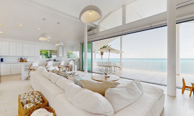Makaha House | Oceanfront home with wrap around lanai, private sauna, beach access & WIFI
