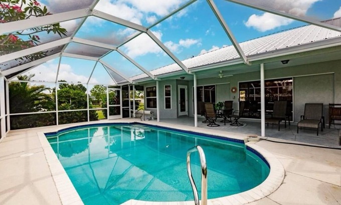 Fort Myers House | Offering breathtaking views of the sun setting over the water.