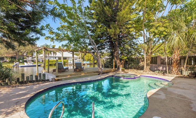 River Isles House | Private wooded 3BR/3BA house w/heated pool on canal just steps from beach