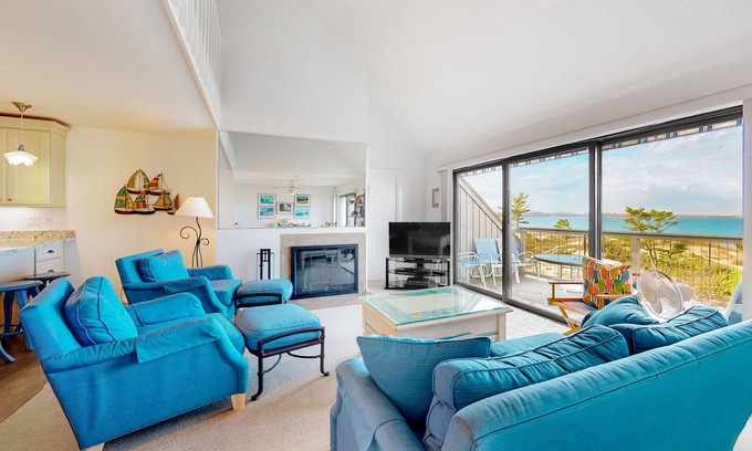 Maple City Condo | Riverfront condo near the lake with beach access, fireplace, balcony & cable