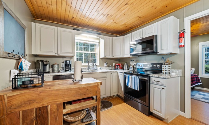 Cherry Log House | Riverfront oasis with hot tub, firepit, game room, & trail access - dog-friendly