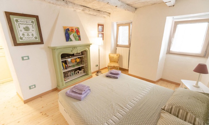 Trarego Viggiona House | Romantic and cuddly double room with fireplace-library and giant shower.