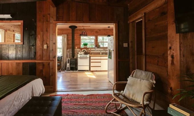 Lakeside Cabin | Secluded 1-bedroom lakefront cabin in Lakeside, OR. Ideal for writers or couples seeking solitude. Features a King bed, wood stove, kayak for 2, and stargazing from your private dock.
