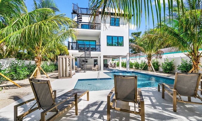 Saint Armands Key House | Showstopping home with a Pool, Rooftop Deck, and Games! Sun-Day Style