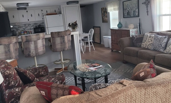 Kiteley House | Spacious mobile home with large kitchen/living area and porch with barbeque.