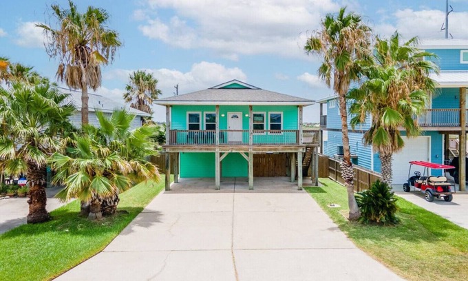 Leeward Sands House | "Step into Shark Attacks and embrace the coastal charm, setting the scene for a refreshing escape. With a spacious open floor plan, it's perfect for family gatherings and unforgettable memories."