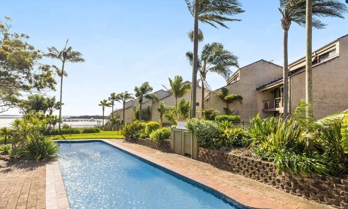 Soldiers Point House | Sunset at The Moorings – newly renovated townhouse on the beach with manicured gardens and pool