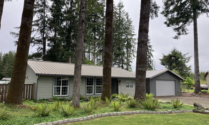 Forks House | Surrounded by trees, this 3-bedroom, fully stocked retreat sleeps 8.