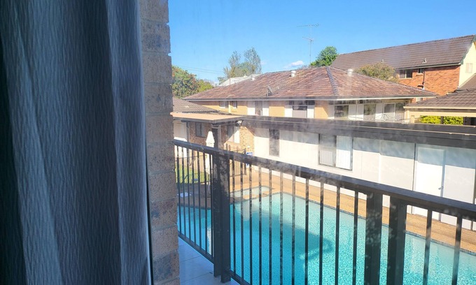 Windsor Apartment | Top View Deluxe Self-Contained Room No 3 with Balcony Overlooking Swimming Pool.
