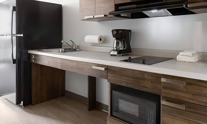Ashwaubenon Hotel | Walk to Packers Games! Room with Kitchen Across the Stadium and Near GRB Airport