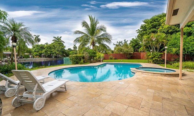 Hollywood House | Waterfront Paradise with Tropical Palms, Swimming Pool & Hot Tub + Huge Backyard