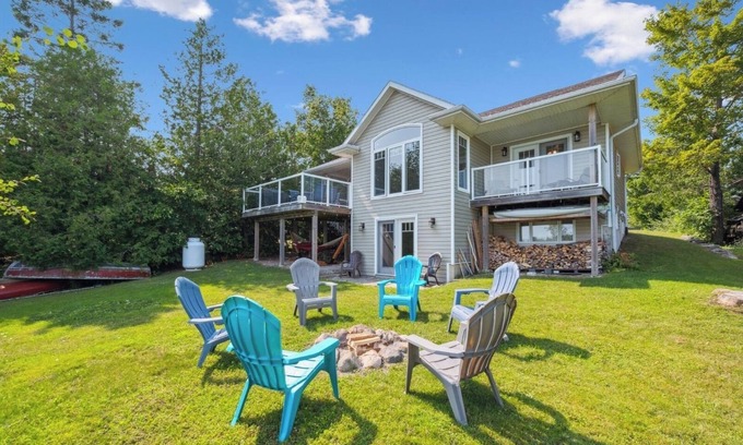 Miller Lake Cottage | Watersedge: 4BR Miller Lake cottage with dock, firepit, decks, spacious interiors, rec room & foosball.