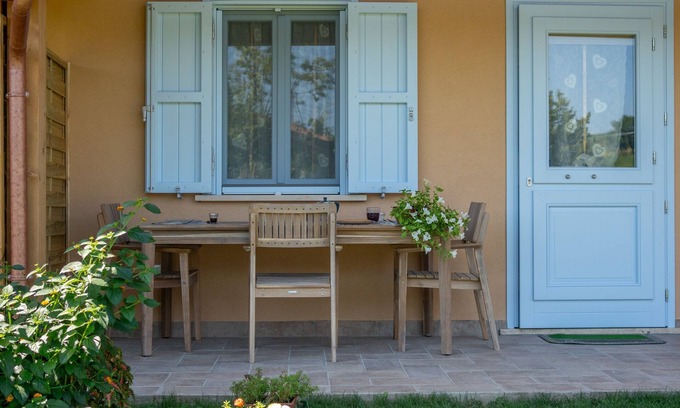 San Brizio Apartment | Wooden house with porch and garden