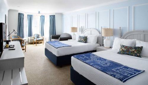 Two Queen Beds With A Loveseat Room