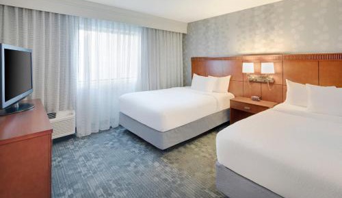 One-Bedroom Suite with Two Double Beds and Sofa Bed - Courtyard View