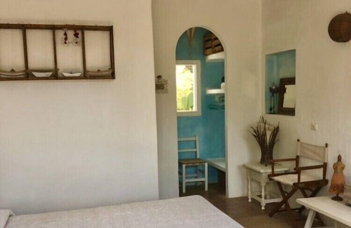 Es Cap de Barbaria House | Formentera. Room immersed in the woods with sea view.