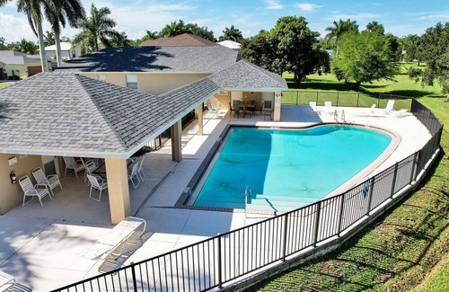 Biggar House | Gated Oasis: Luxurious 5-BR Retreat in Ft. Myers