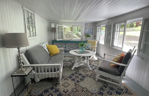 Greene Cottage | Rustic cottage surrounded by trees, overlooking a creek.