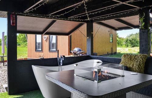 Storwood Cottage | We just love the outside entertainment area with a bath for two, table top fire pit and large Smart