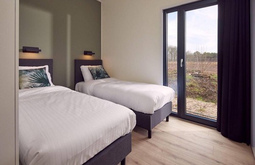 Lattrop House | The Amalia 4 Eco is a luxurious holiday home with a private sauna, a spacious living room, open kitchen, two bedrooms and a spacious patio.