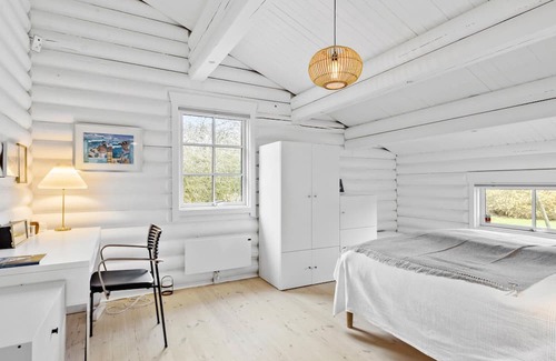 Dronningmolle House | Relax in this beautiful log cabin near the beach.