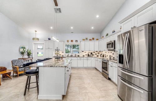 Pine Island Center House | Canal-side charmer with enclosed pool, waterside deck, open layout, & W/D