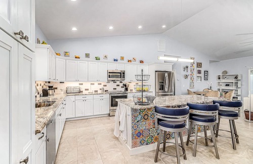 Pine Island Center House | Canal-side charmer with enclosed pool, waterside deck, open layout, & W/D