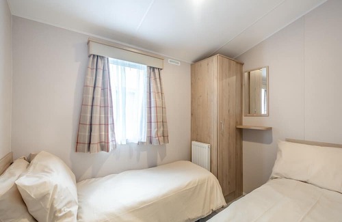Sandyhills House | This spacious 2 bedroom caravan sleeps 4 people in one double and one twin bedroom.