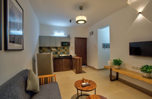 Vagator Apartment | Chic 1BHK Vagator, French Windows in both living room and bedroom.
