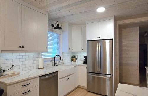 Christopher Lake Cabin | Emma Lake Sunset Bay retreat! One minute walk to the beach with large deck/yard!