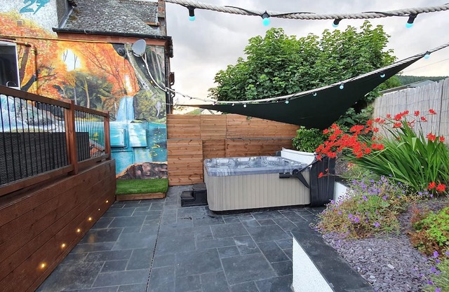 Relax in this luxury renovated flat with a hot tub and log burner