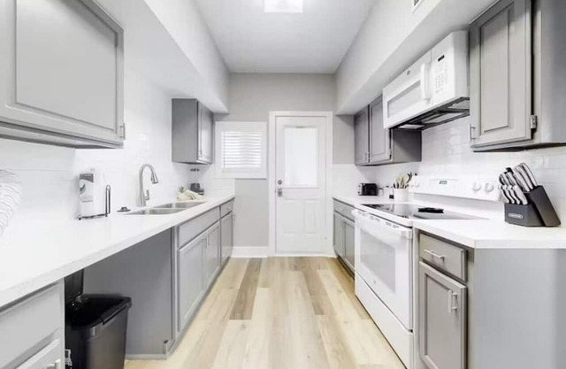 Centrally located unit with shared courtyard, designated hot tub, & fire pit!