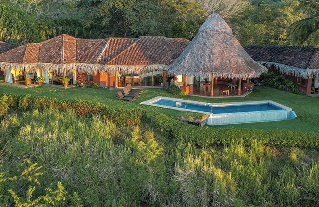 Walk to the beach from 4 bedroom house w/ salt water infinity pool.