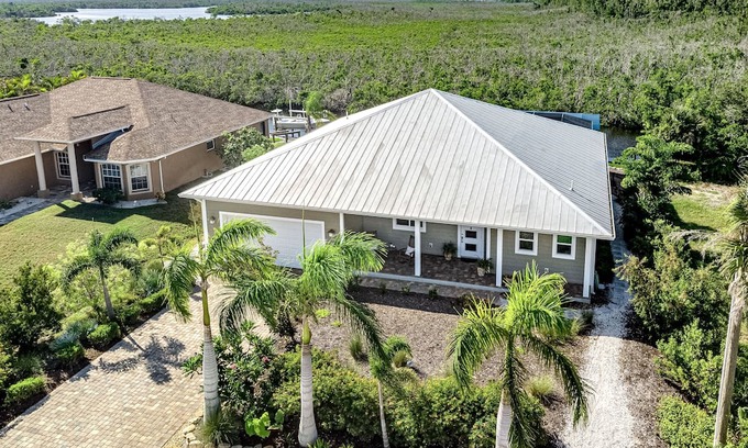 Pine Island Center House | Canal-side charmer with enclosed pool, waterside deck, open layout, & W/D