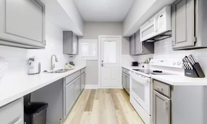 Galveston Cabin | Centrally located unit with shared courtyard, designated hot tub, & fire pit!
